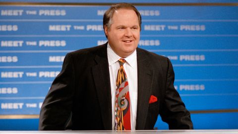 Rush Limbaugh in a black coat and red tie caught on the camera.